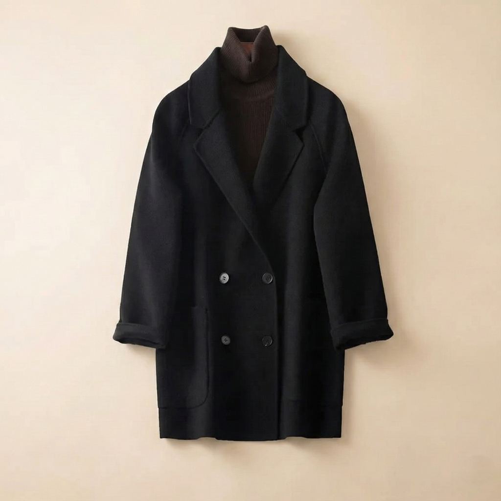 Woman wearing a gray double-breasted coat with rolled cuffs and notched lapels over a black turtleneck_11