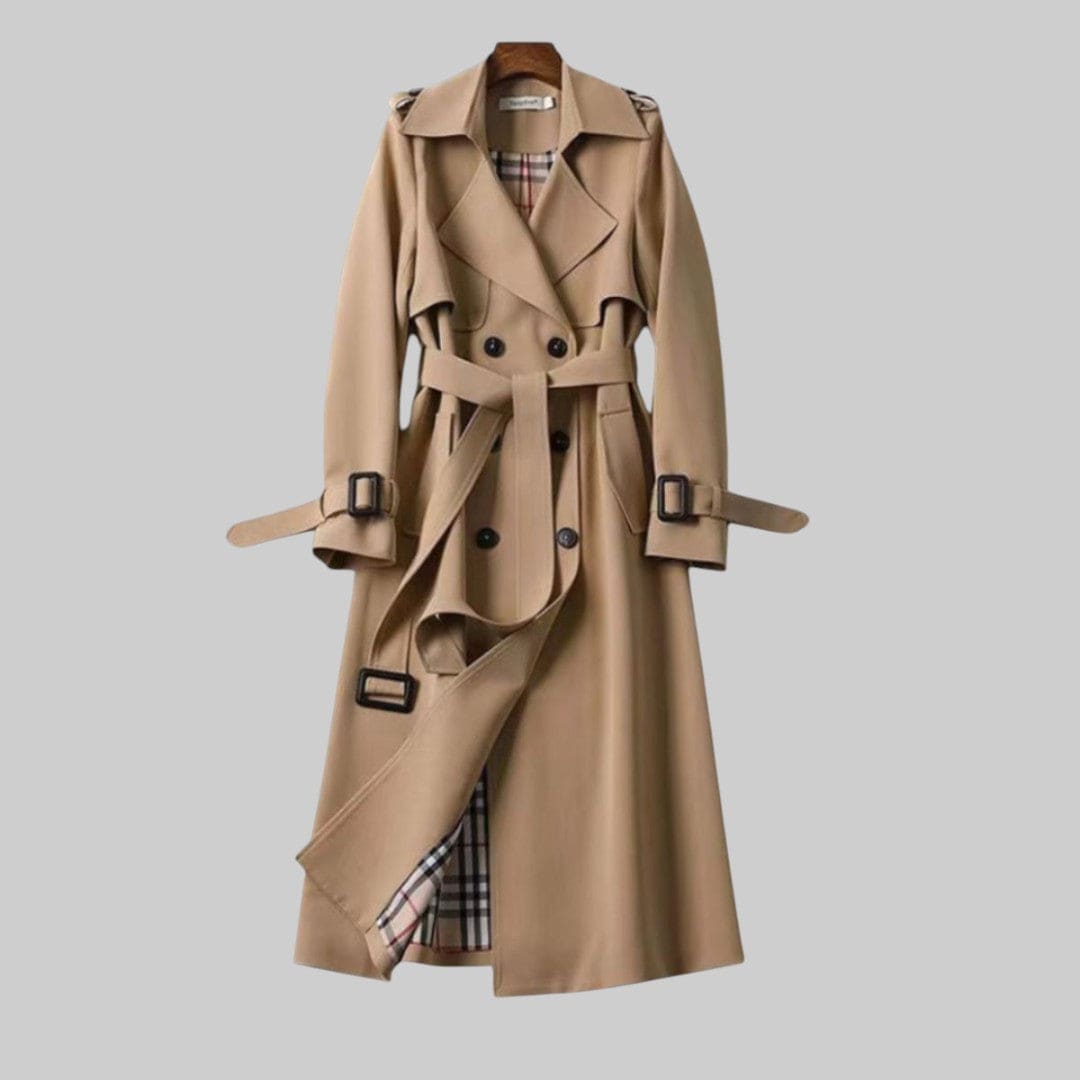 A longline trench coat with double breasted front, belted waist, lapel collar, and adjustable cuff straps displayed on a hanger._0