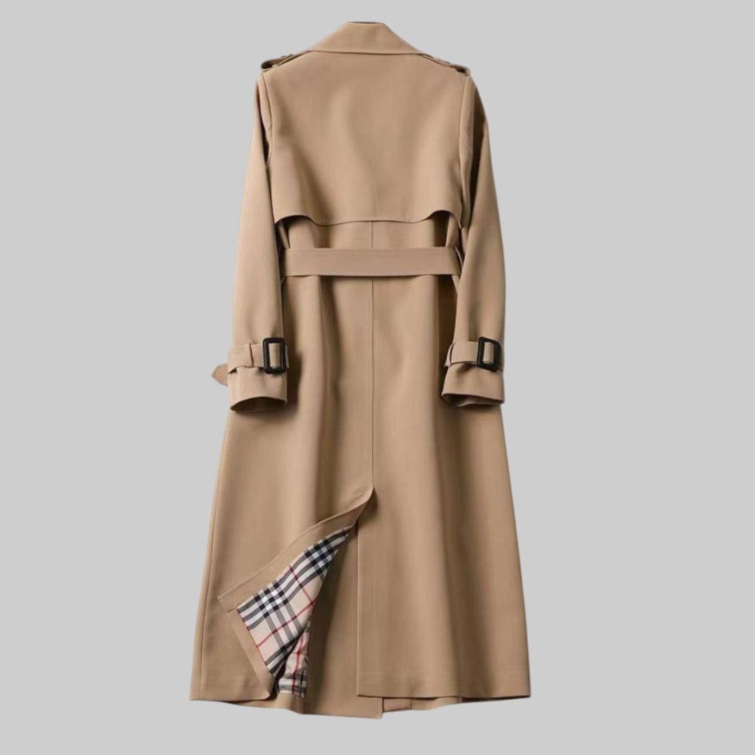 A longline trench coat with double breasted front, belted waist, lapel collar, and adjustable cuff straps displayed on a hanger._5