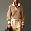 Woman wearing a camel half-zip sweater with cream collar, cuffs and hem, paired with cream trousers and gold jewellery._0
