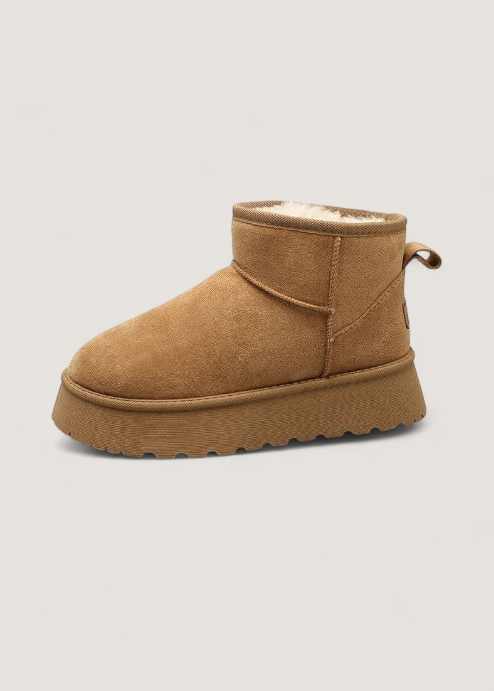 Tan platform ankle boot in side view with a rounded toe, ankle collar, and back pull tab.