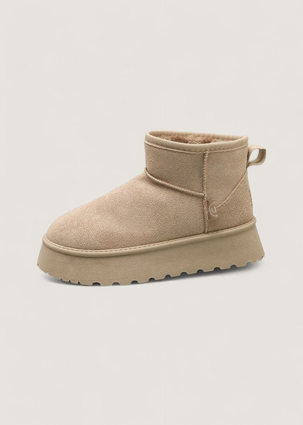 Light beige platform ankle boot displayed in side profile, highlighting the stitched upper and textured sole.