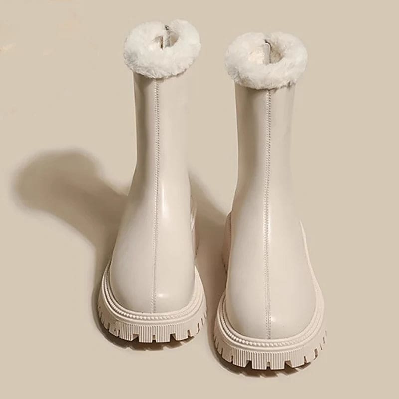 Pair of tall boots with fleece lining around the cuff, front zipper closure, and chunky treaded sole, shown from the front on a neutral beige background._0