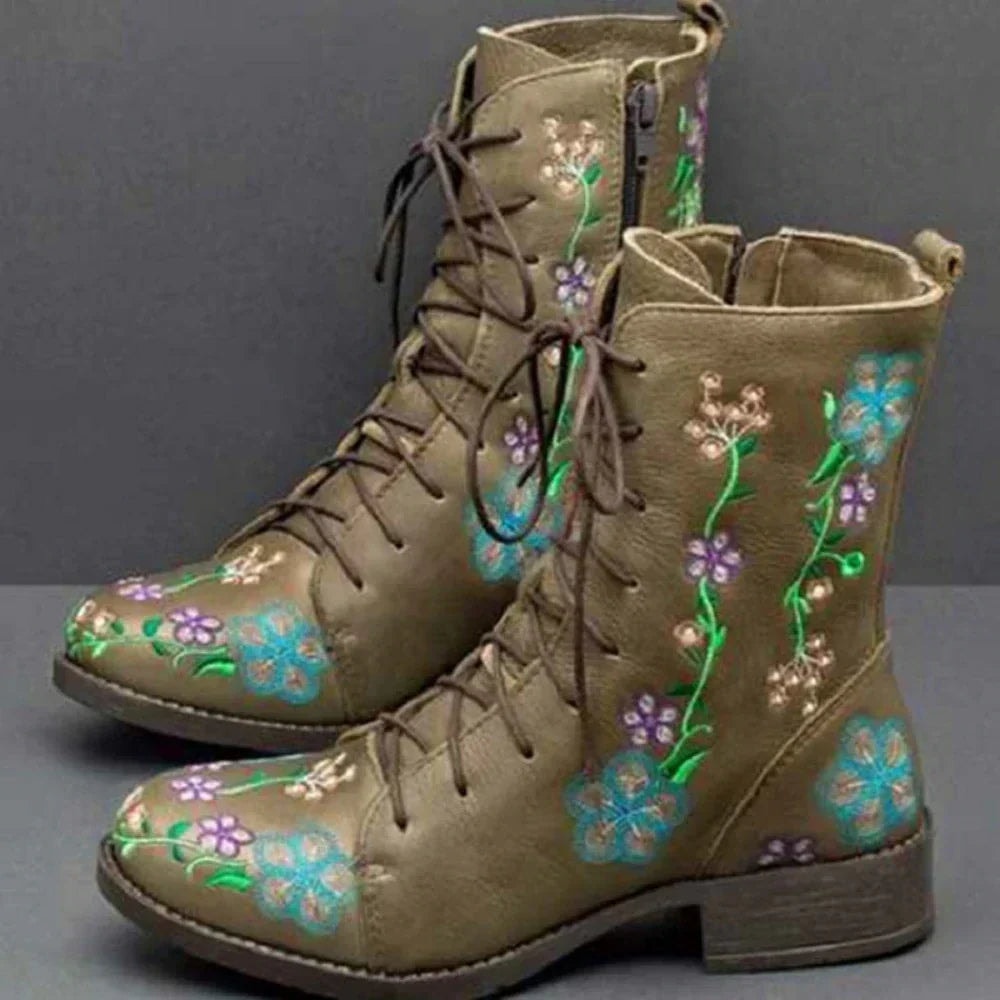 Olive ankle boots with colorful floral and vine embroidery, lace-up fronts, side zippers, and low block heels.