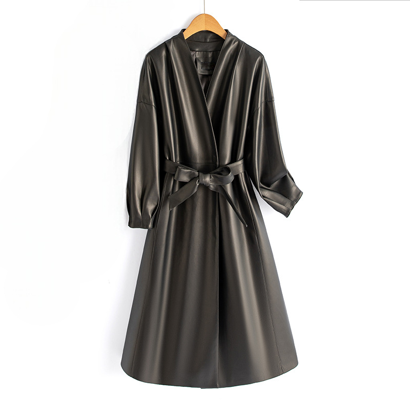 A long-sleeve wrap coat with a V neckline, self-tie waist belt, and softly flared skirt hangs on a wooden hanger._0