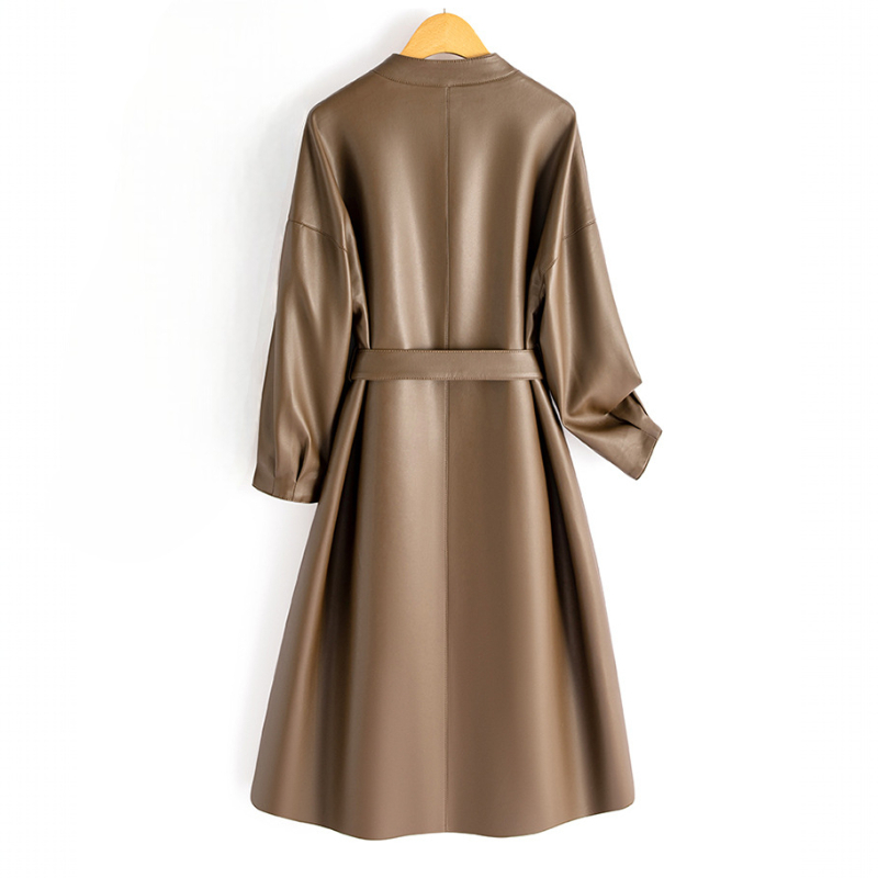 A long-sleeve wrap coat with a V neckline, self-tie waist belt, and softly flared skirt hangs on a wooden hanger._3