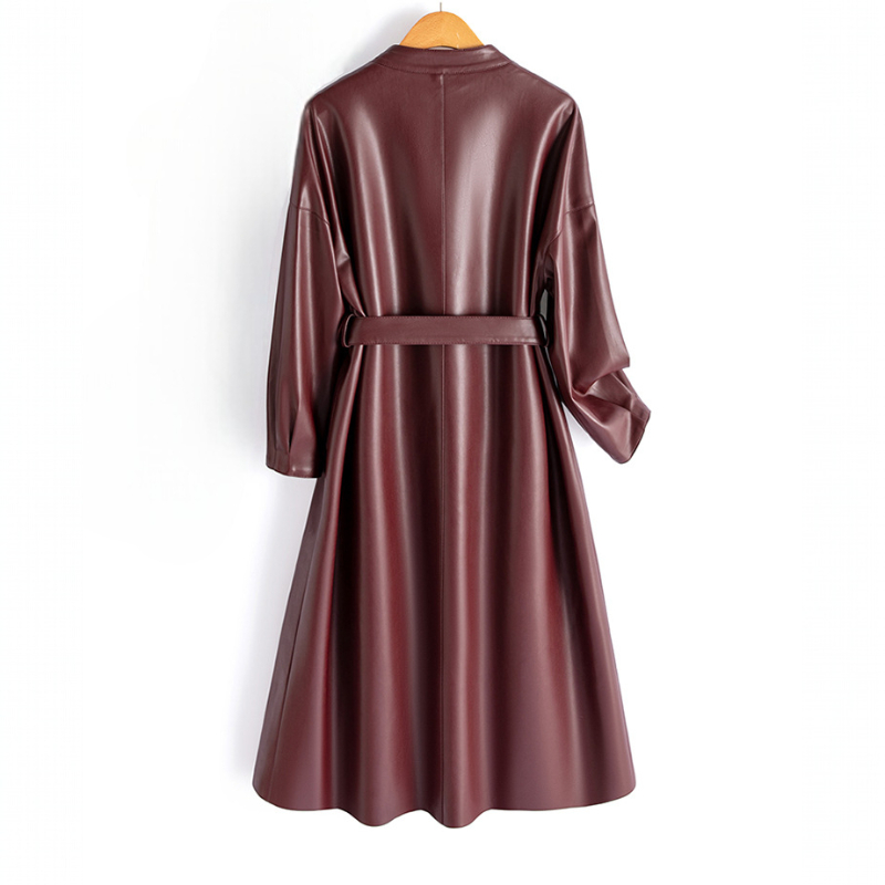 A long-sleeve wrap coat with a V neckline, self-tie waist belt, and softly flared skirt hangs on a wooden hanger._5