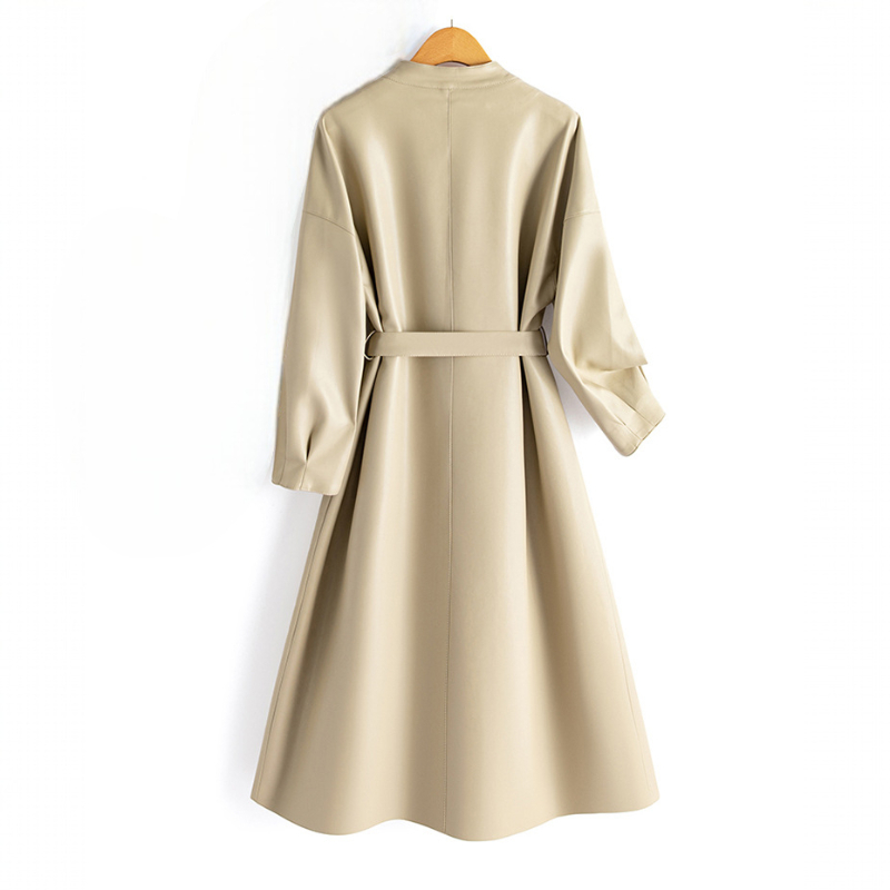 A long-sleeve wrap coat with a V neckline, self-tie waist belt, and softly flared skirt hangs on a wooden hanger._9