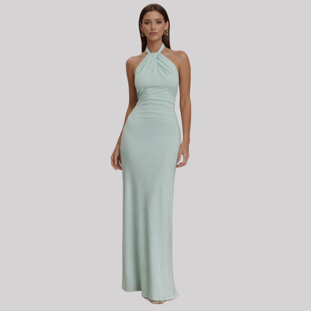 Model wearing a halter neck maxi dress with bodycon fit, open back design, and floor-length hem in a soft pastel shade._0