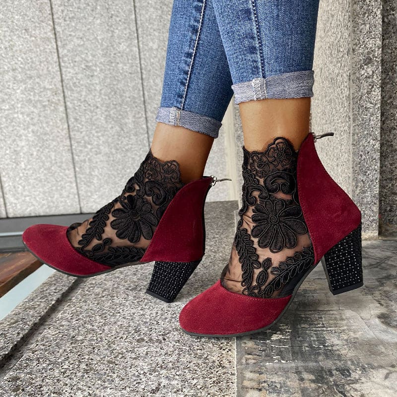 Woman wearing heeled ankle boots featuring sheer floral lace panels, solid toe and heel, and studded block heel detail with cuffed jeans._4