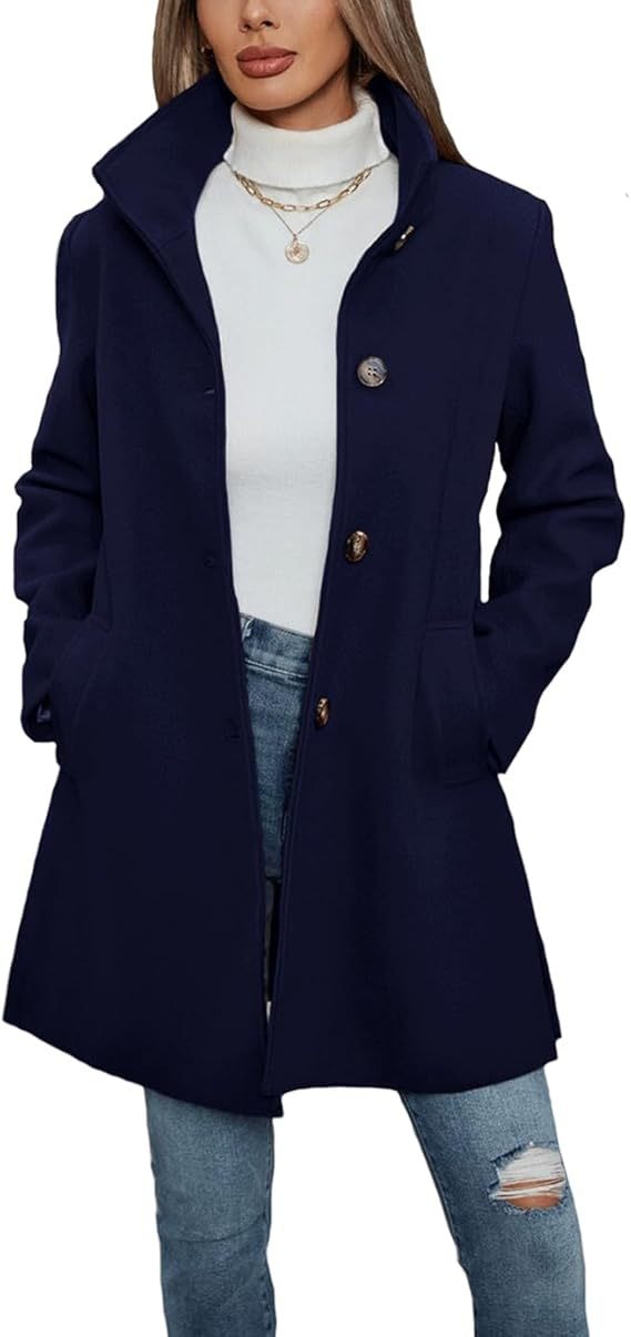 Close-up view of the navy coat showing its front fastening, raised collar, and long sleeves.