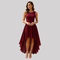 Woman wearing a high-low sleeveless dress with lace bodice and asymmetric flowing skirt in a deep burgundy shade, styled with strappy heeled sandals_0