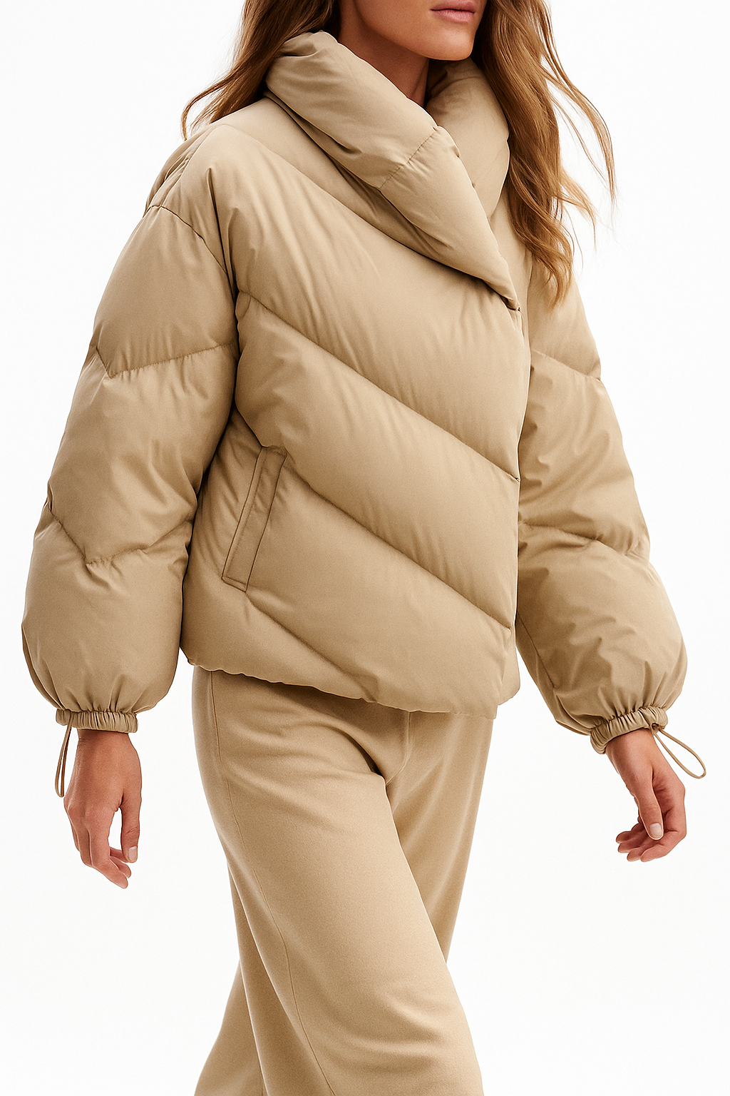 Woman wearing a hooded quilted puffer jacket in a cropped relaxed fit, styled with a light sweater and trousers._10