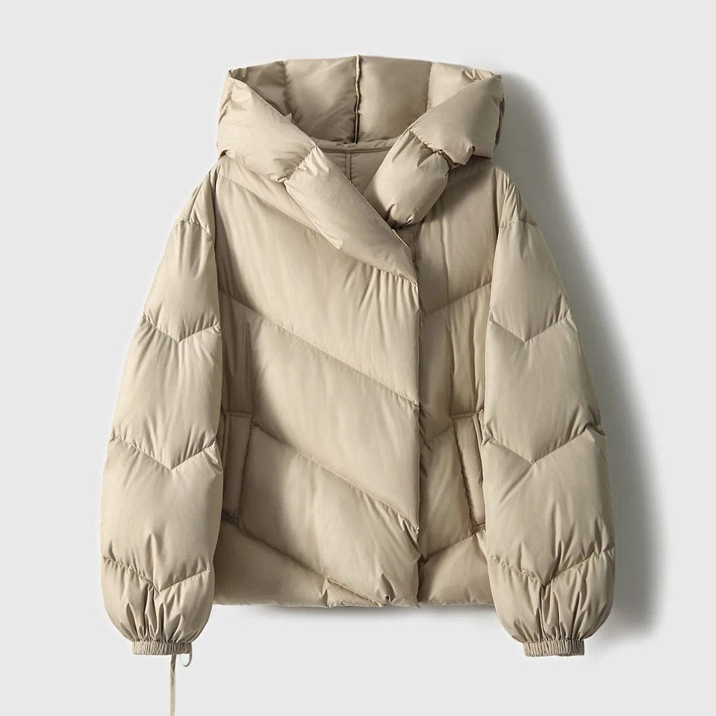 Woman wearing a hooded quilted puffer jacket in a cropped relaxed fit, styled with a light sweater and trousers._14