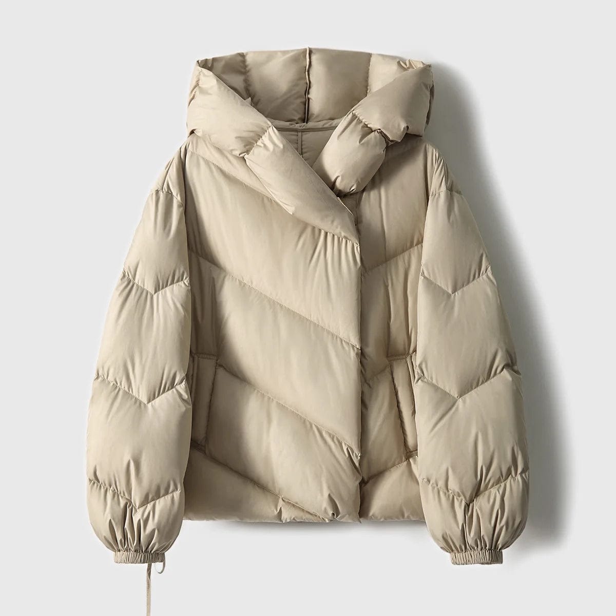 Woman wearing a hooded quilted puffer jacket in a cropped relaxed fit, styled with a light sweater and trousers._14