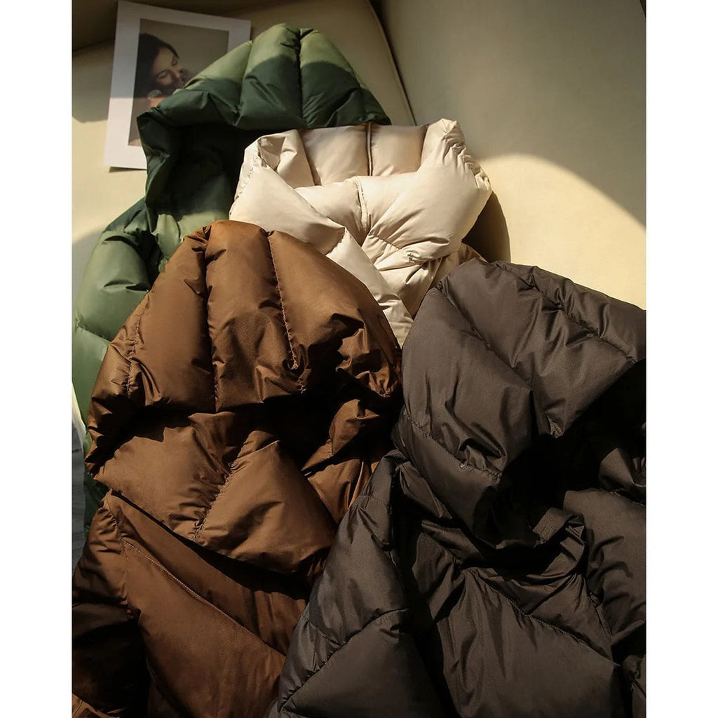 Woman wearing a hooded quilted puffer jacket in a cropped relaxed fit, styled with a light sweater and trousers._15