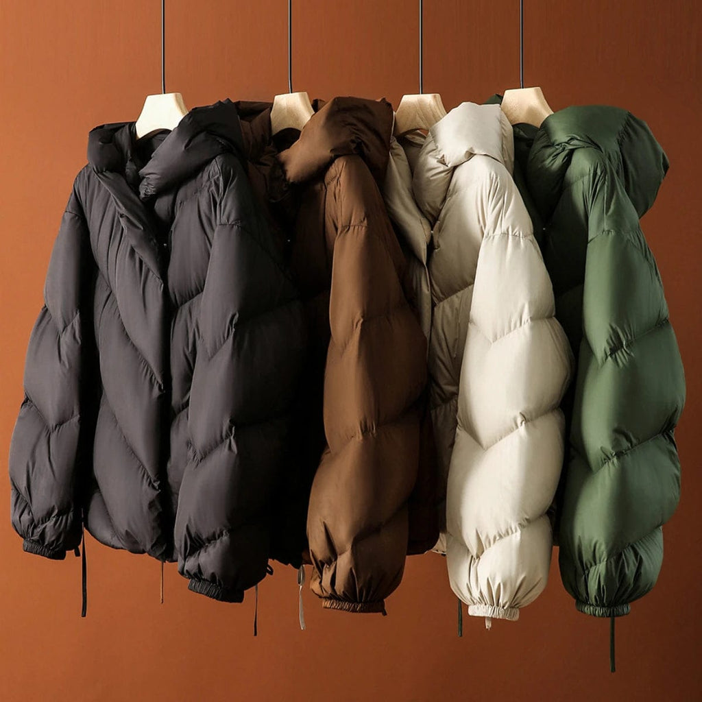 Woman wearing a hooded quilted puffer jacket in a cropped relaxed fit, styled with a light sweater and trousers._16