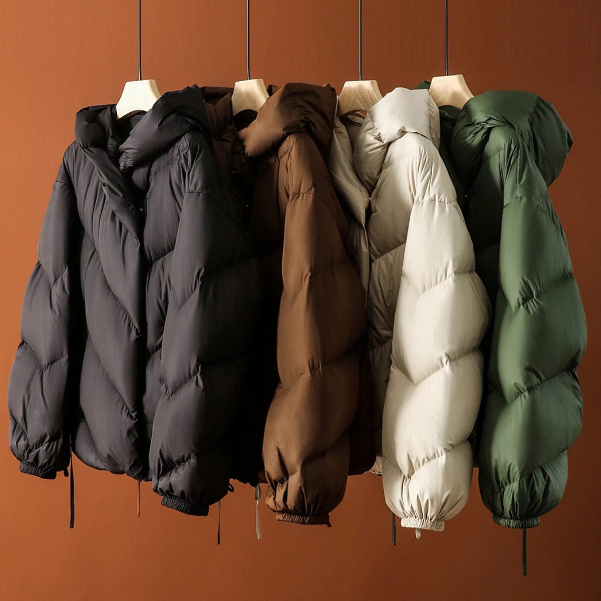 Woman wearing a hooded quilted puffer jacket in a cropped relaxed fit, styled with a light sweater and trousers._16