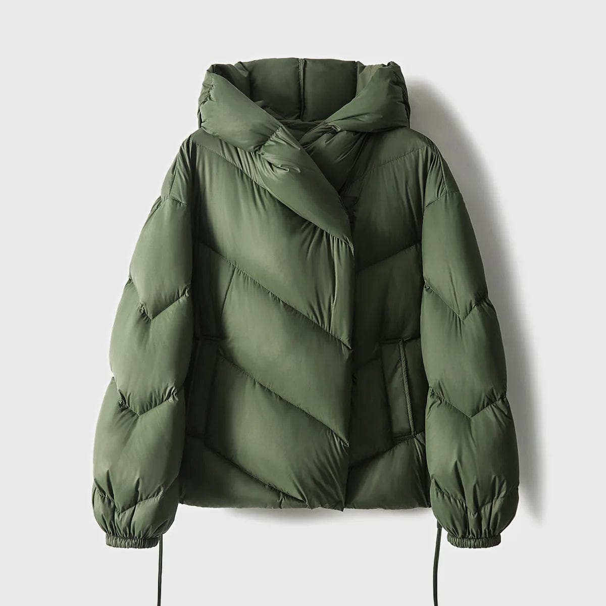 Woman wearing a hooded quilted puffer jacket in a cropped relaxed fit, styled with a light sweater and trousers._18