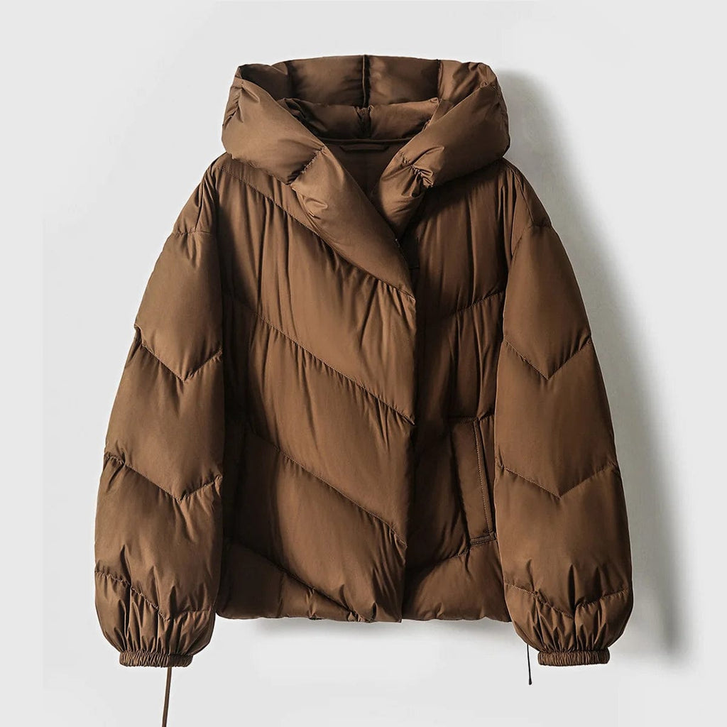 Woman wearing a hooded quilted puffer jacket in a cropped relaxed fit, styled with a light sweater and trousers._19