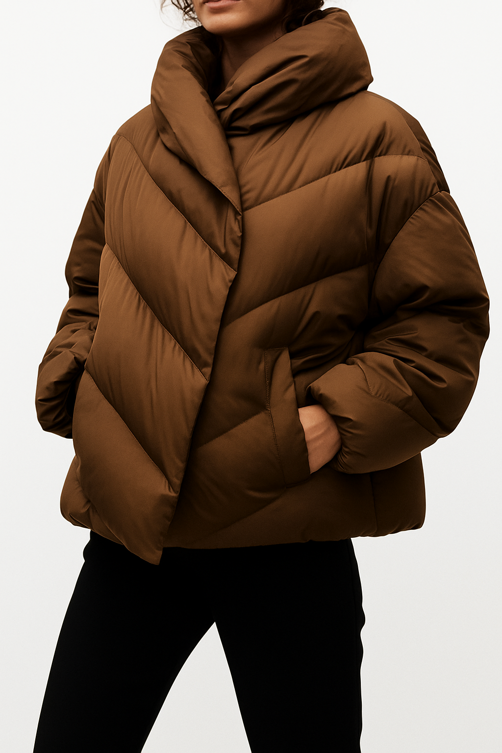 Woman wearing a hooded quilted puffer jacket in a cropped relaxed fit, styled with a light sweater and trousers._6