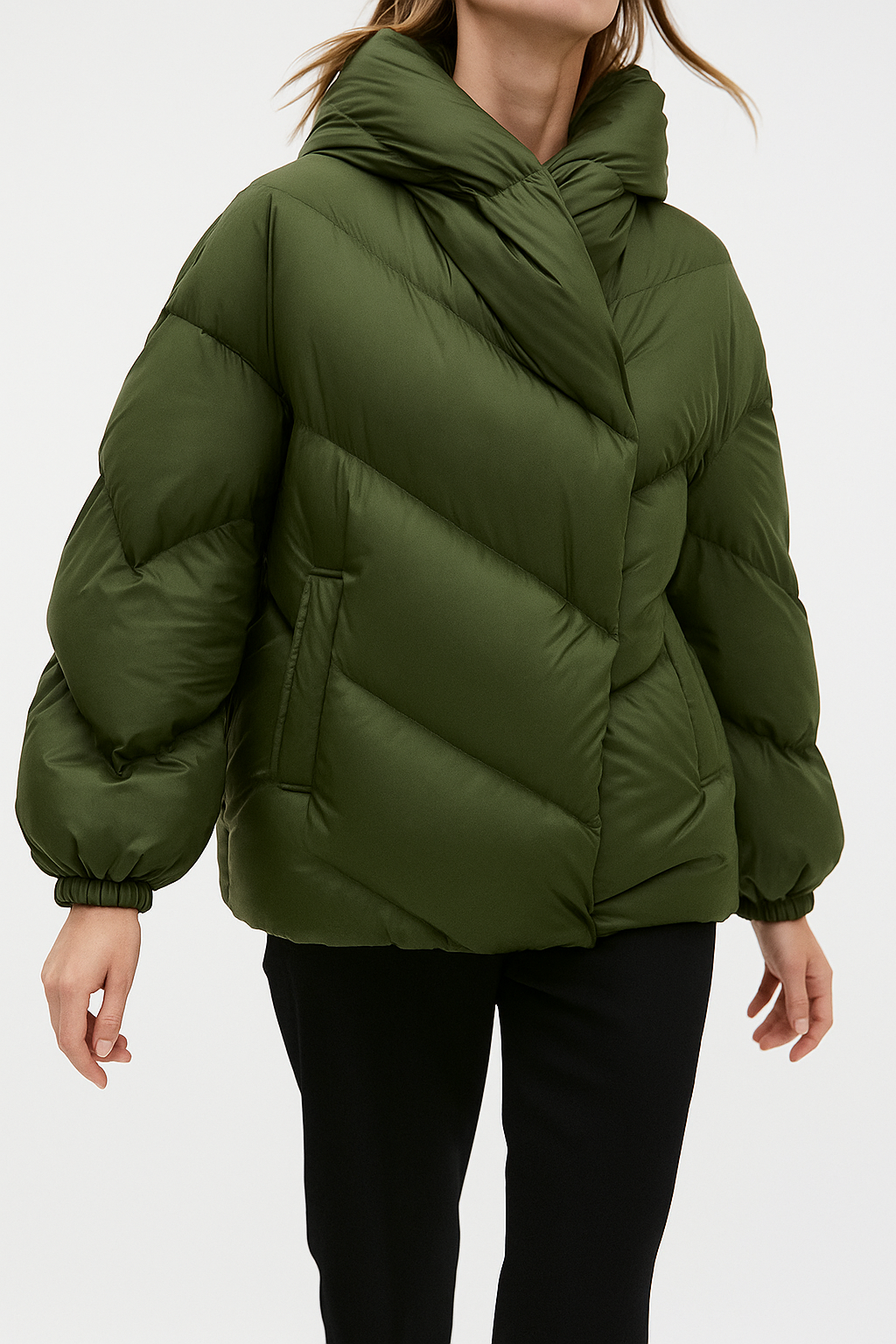 Woman wearing a hooded quilted puffer jacket in a cropped relaxed fit, styled with a light sweater and trousers._8