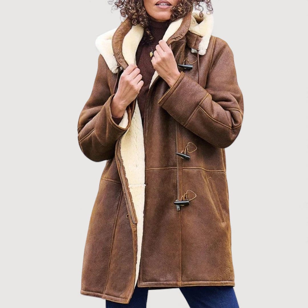 Woman wearing a brown hooded toggle coat with a sherpa collar and warm lining._0