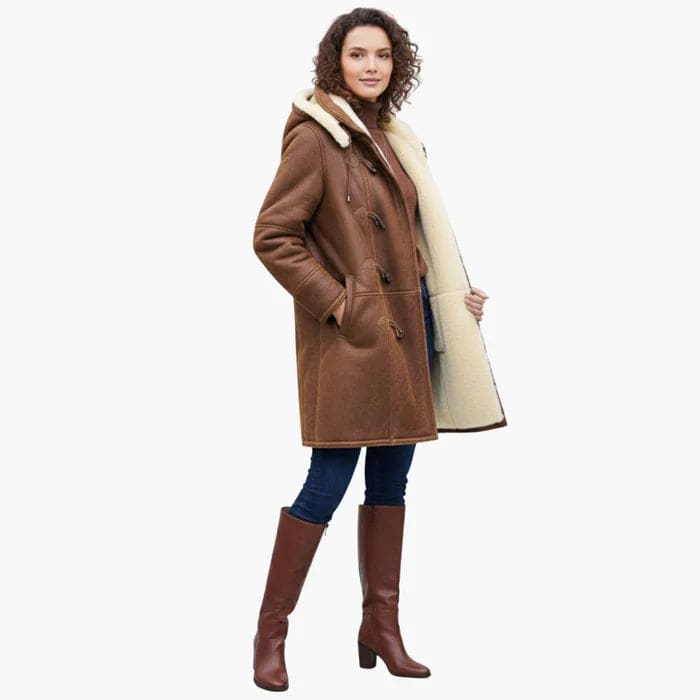 Woman wearing a brown hooded toggle coat with a sherpa collar and warm lining._2
