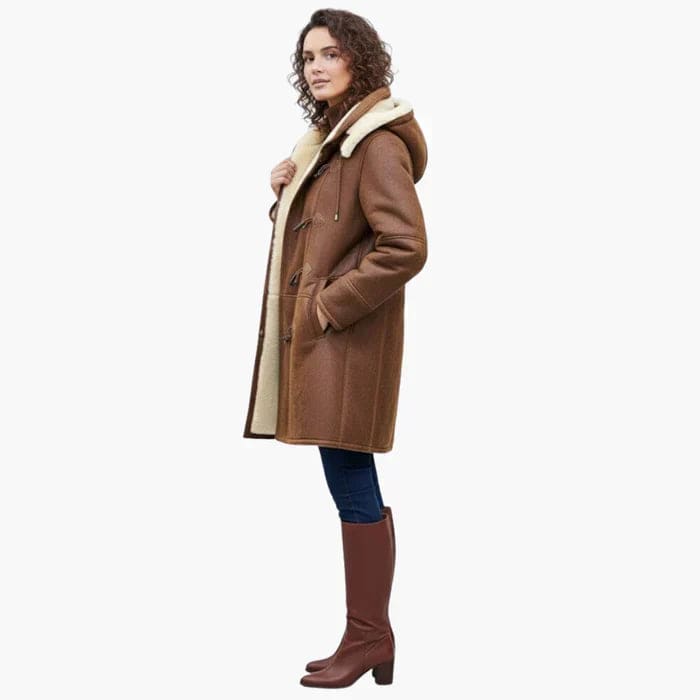 Woman wearing a brown hooded toggle coat with a sherpa collar and warm lining._3