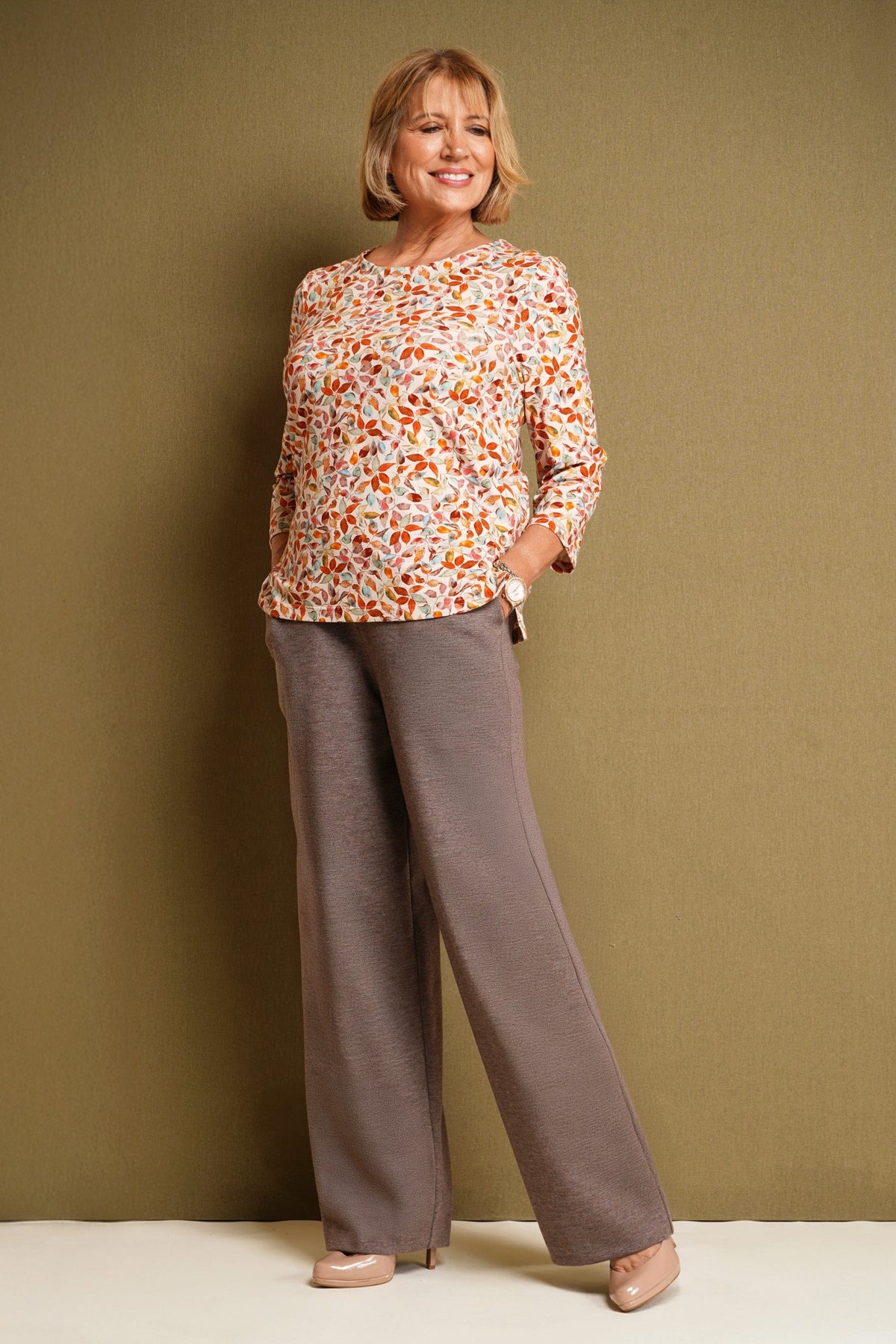Woman wearing light blue wide leg trousers with an elasticated waistband and side pockets, styled with a floral blouse and black heels._5