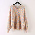 Oversized v-neck sweater on a black hanger, knitted in a speckled multicolor yarn of pink, blue, yellow and cream on a cream base, with long blouson sleeves and ribbed cuffs and hem._0