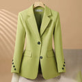 A tailored blazer with notched lapels, a two button front, flap pockets, and decorative cuff buttons displayed on a hanger._0