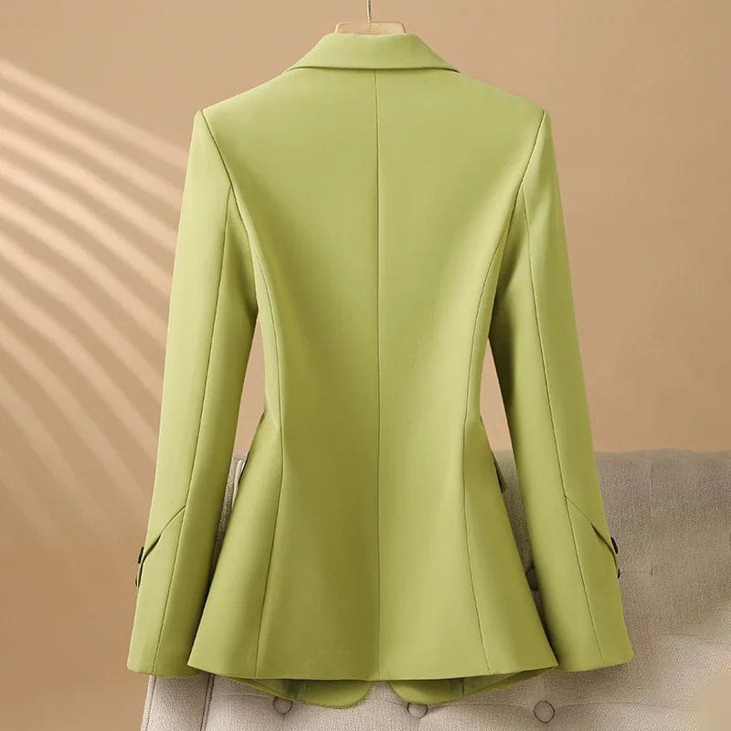 A tailored blazer with notched lapels, a two button front, flap pockets, and decorative cuff buttons displayed on a hanger._1