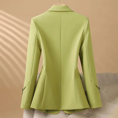 A tailored blazer with notched lapels, a two button front, flap pockets, and decorative cuff buttons displayed on a hanger._1