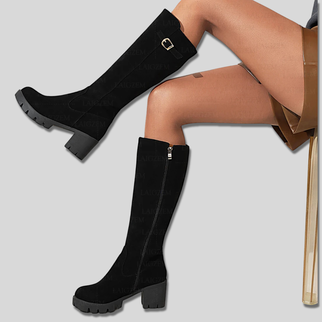 Model wearing knee high boots with block heel and side zipper detail._0