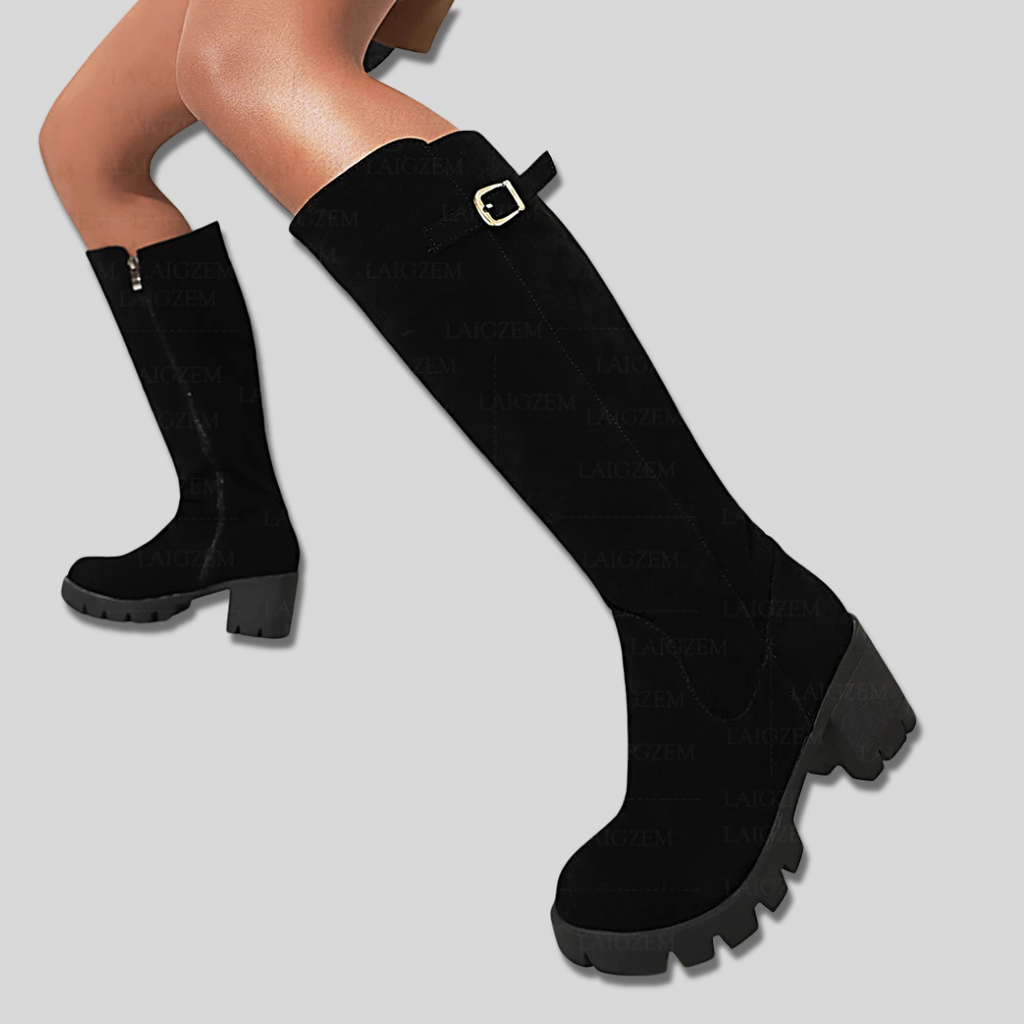 Model wearing knee high boots with block heel and side zipper detail._3
