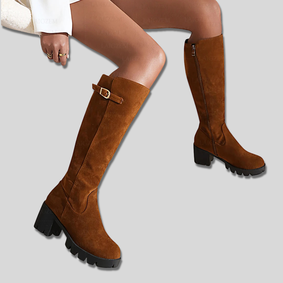 Model wearing knee high boots with block heel and side zipper detail._4