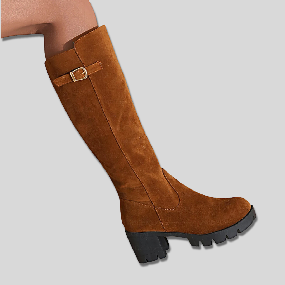 Model wearing knee high boots with block heel and side zipper detail._5
