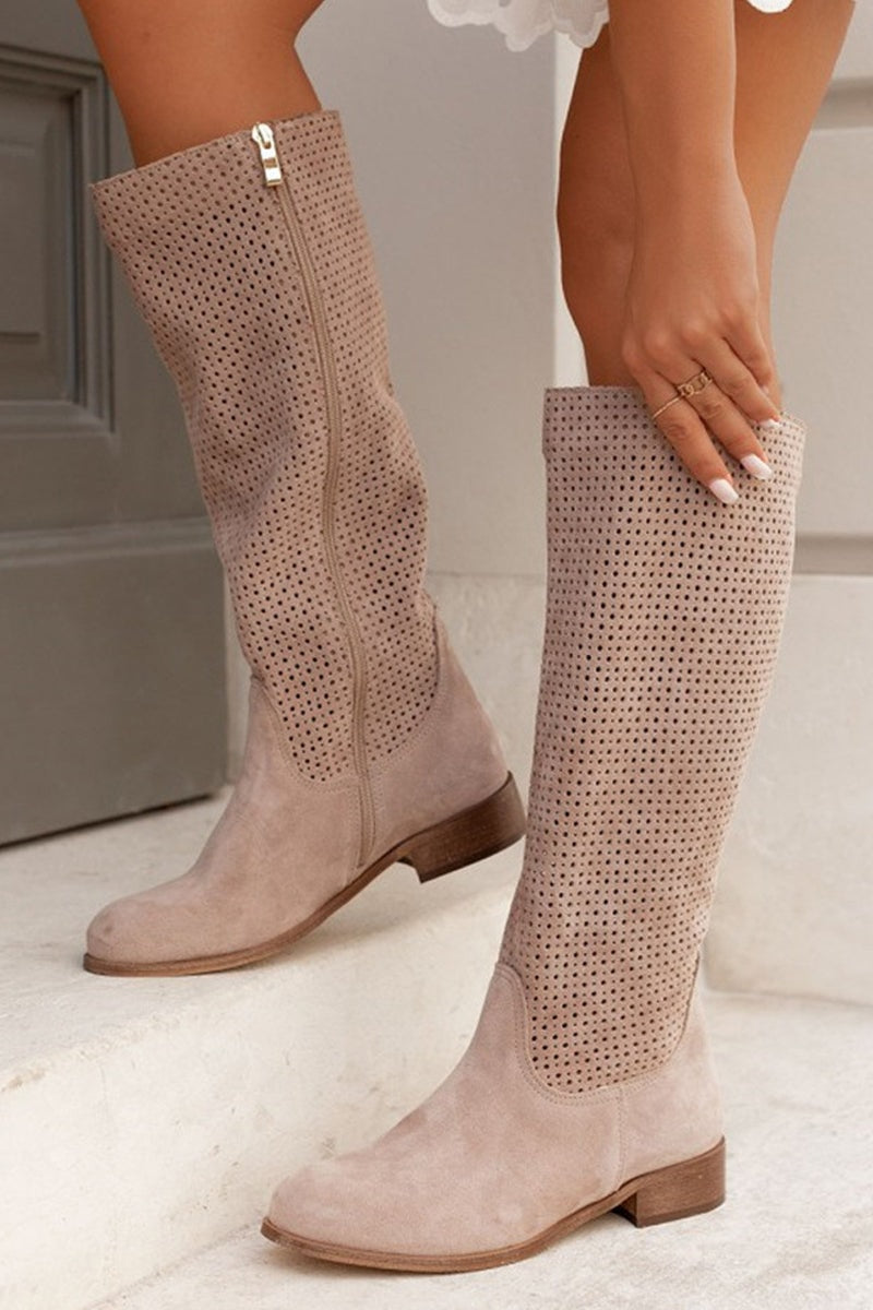 Pair of taupe knee-high perforated boots shown from the side, highlighting the shaft zippers and low block heels.
