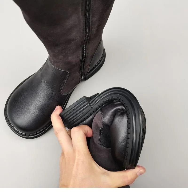Pair of knee high riding boots with side zipper and plush lining shown from above._24