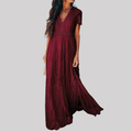 Woman wearing a deep burgundy red maxi dress with intricate lace detailing, v-neckline, short sleeves, and full-length flowing skirt._0