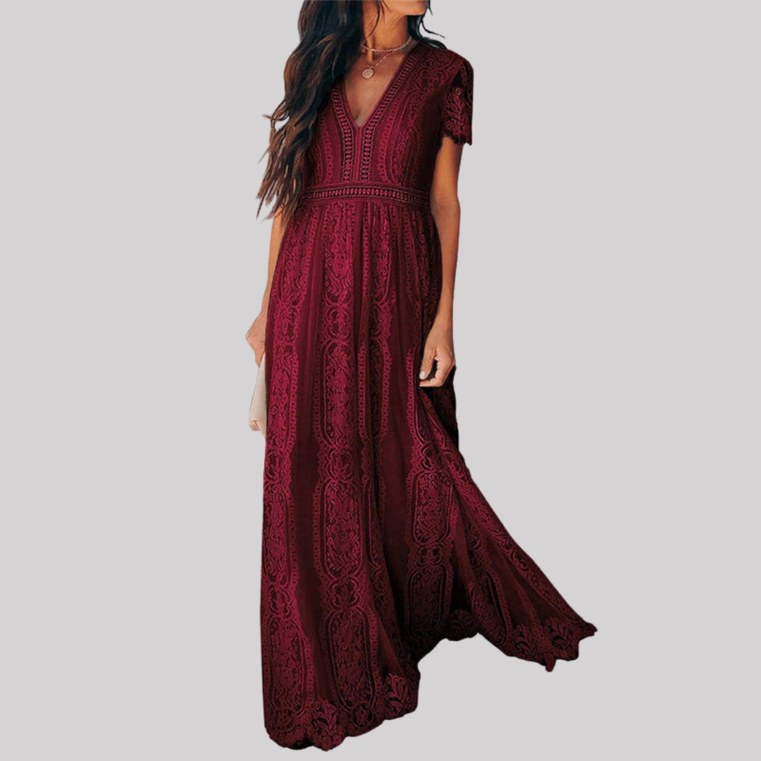 Woman wearing a deep burgundy red maxi dress with intricate lace detailing, v-neckline, short sleeves, and full-length flowing skirt._0