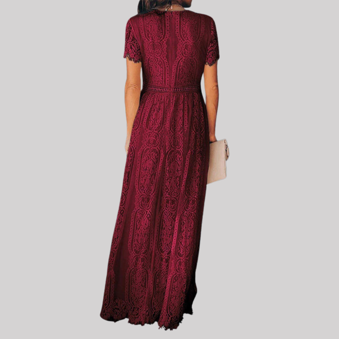 Woman wearing a deep burgundy red maxi dress with intricate lace detailing, v-neckline, short sleeves, and full-length flowing skirt._1