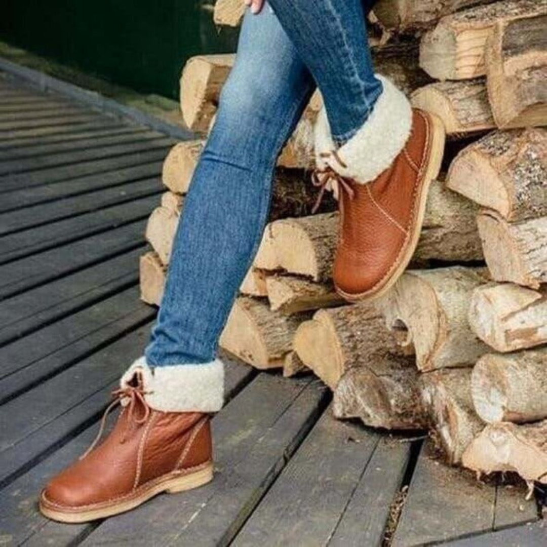 A mid-calf boot in dark grey with a textured upper, lace-up detail at the top, contrast stitching, and a light-colored cushioned sole._6