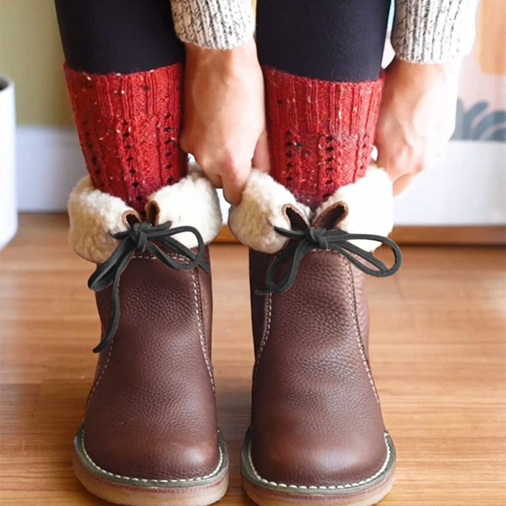 A mid-calf boot in dark grey with a textured upper, lace-up detail at the top, contrast stitching, and a light-colored cushioned sole._7