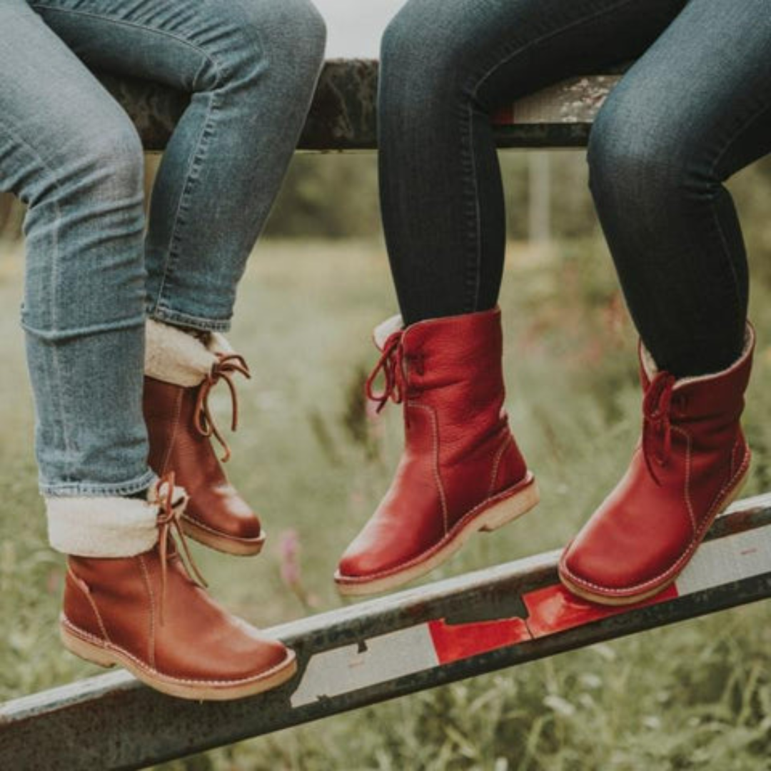 A mid-calf boot in dark grey with a textured upper, lace-up detail at the top, contrast stitching, and a light-colored cushioned sole._8