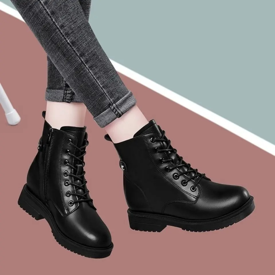 Pair of black lace-up ankle boots shown at an angle, with smooth rounded toes, side zippers, low block heels, and textured soles.
