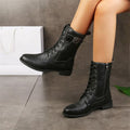 Woman wearing mid-calf combat boots with lace-up front, side zipper, buckle detail, and low block heel_0