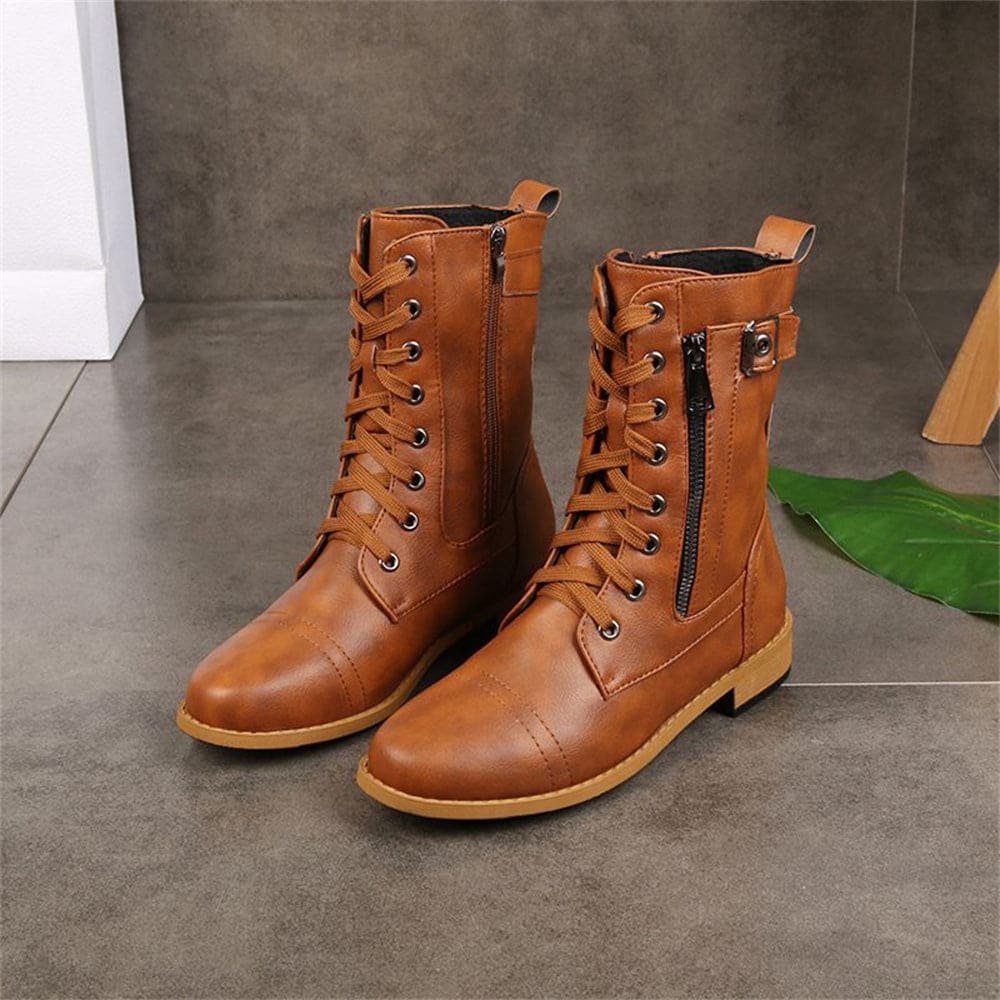 Woman wearing mid-calf combat boots with lace-up front, side zipper, buckle detail, and low block heel_15
