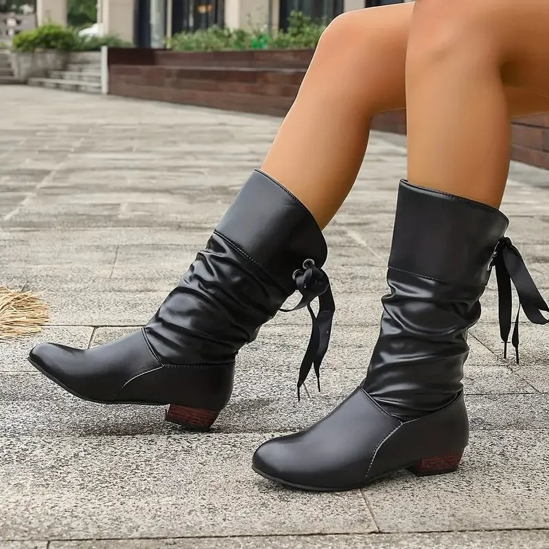 Black slouch calf boots shown from the front-side angle with contrasting gathered shafts and lace ties.